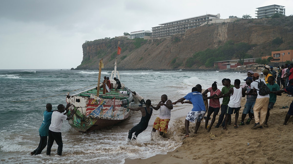 People pulling capsized boat