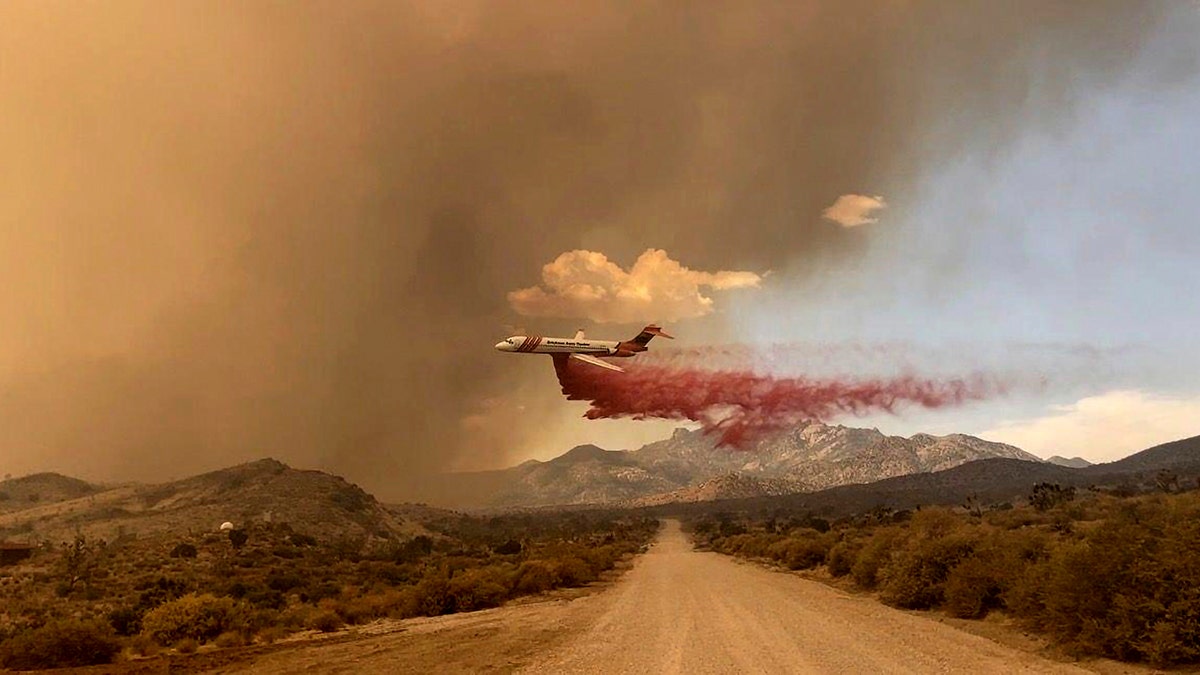 Tanker making fire retardant drop