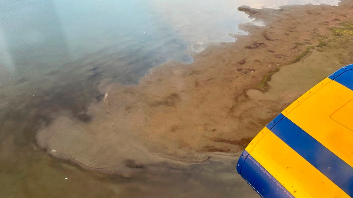 An aerial view of a shallow lake where a helicopter crashed in Alaska