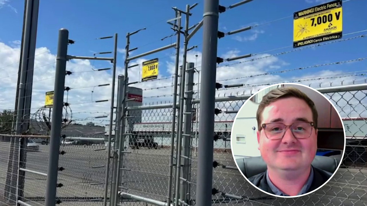 Mans face in front of fence