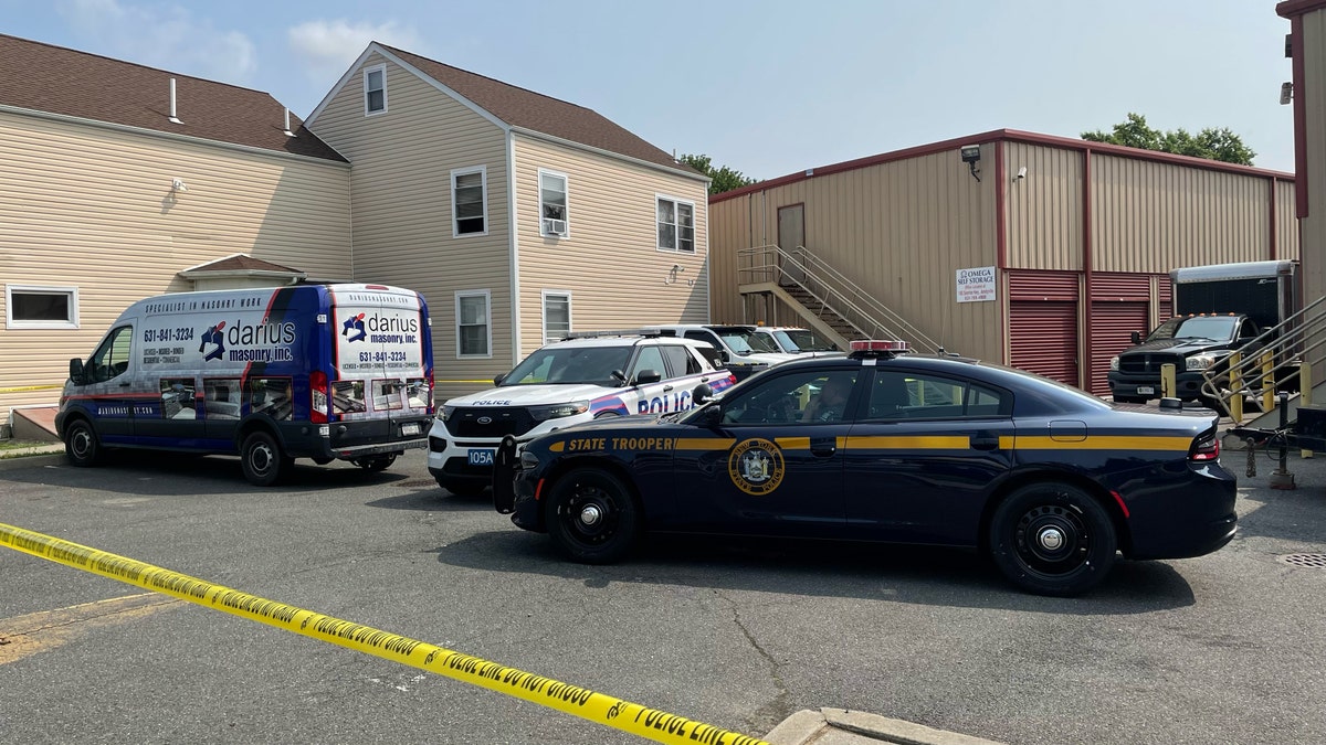 Police cars parked outside storage unit in Amityville, NY