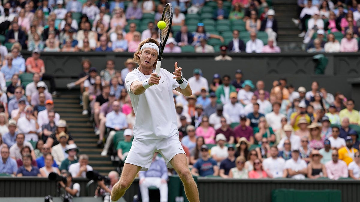 Andrey Rublev holds his racket