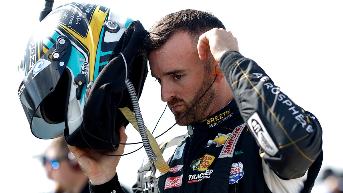 Austin Dillon puts his helmet on