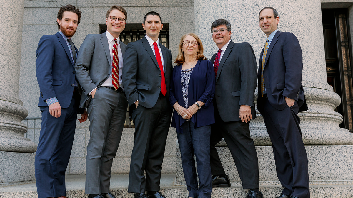 Debra Vitagliano flanked by legal team