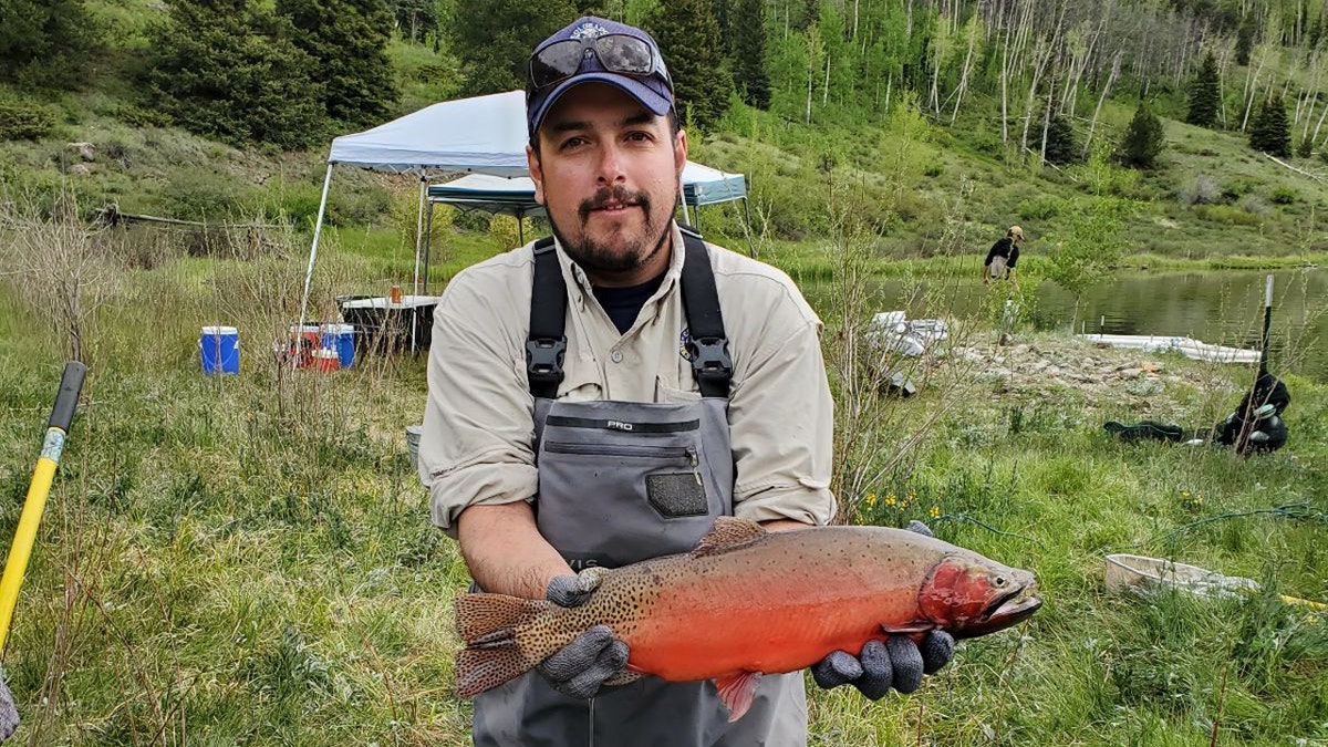 Estevan Vigil holds Rio Grande cutthroat trout