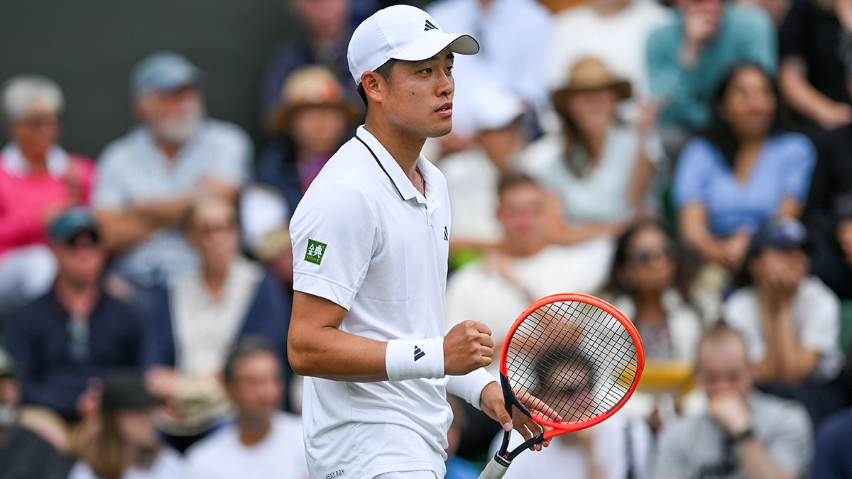 Yibing Wu celebrates during a Wimbledon match