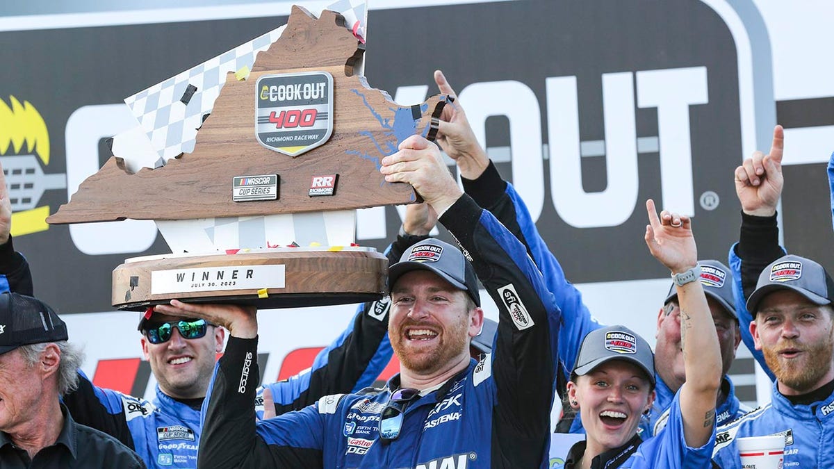 Chris Buescher holds the cookout trophy
