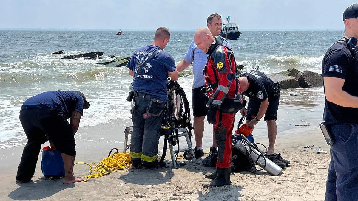 A diver gets geared-up to find the missing swimmer in Coney Island.
