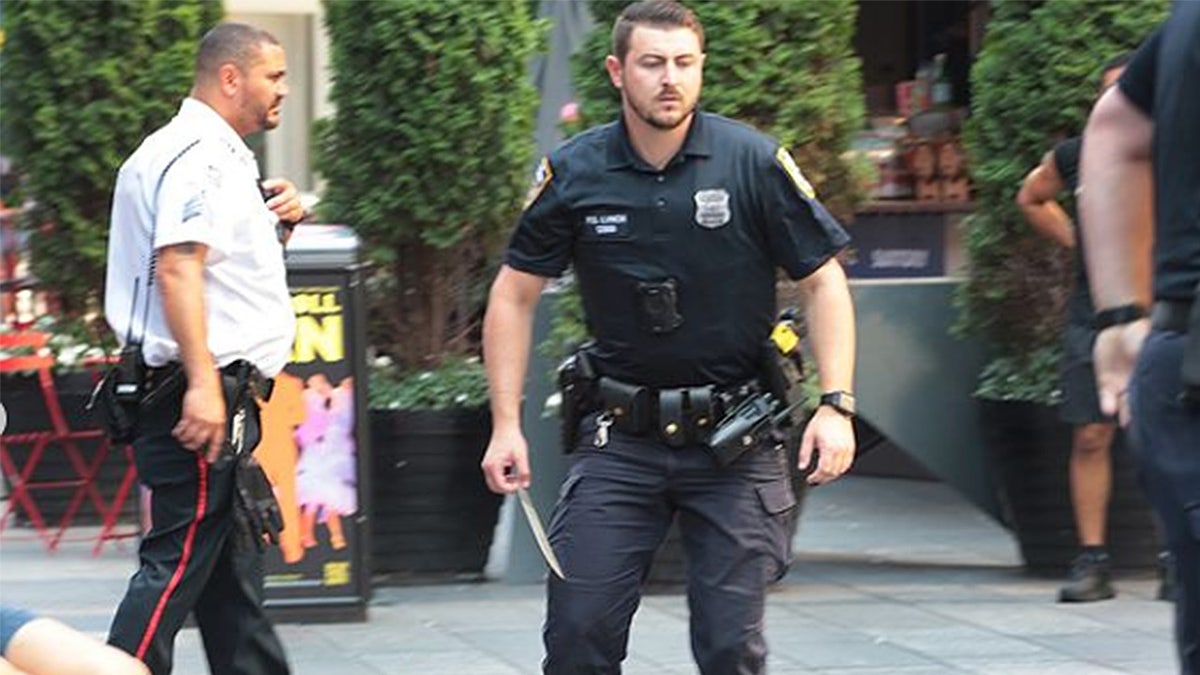 New York City police officer holds a six-inch knife in Times Square.