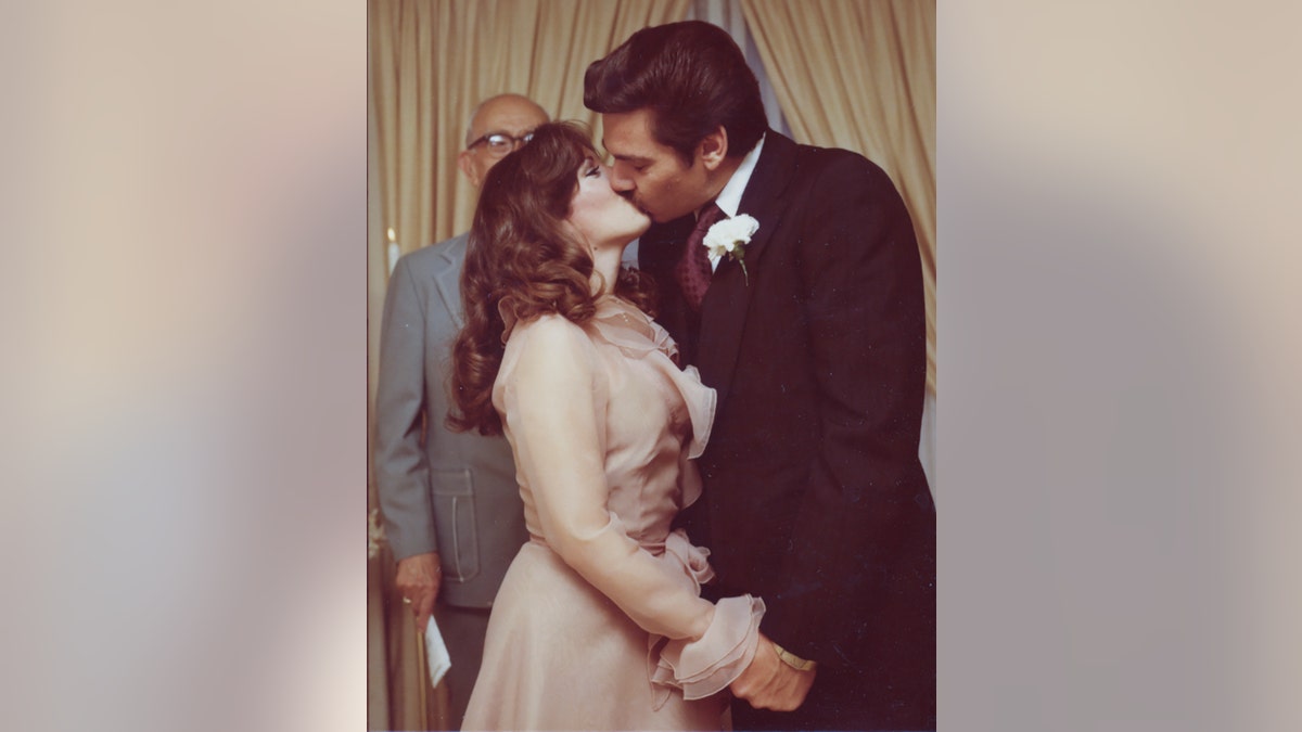 Victoria Hallman kissing her husband on her wedding day