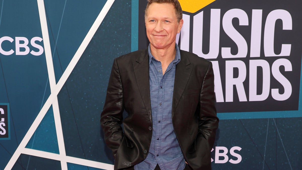 Craig Morgan wearing a suit jacket in from of CMT Music Awards signage