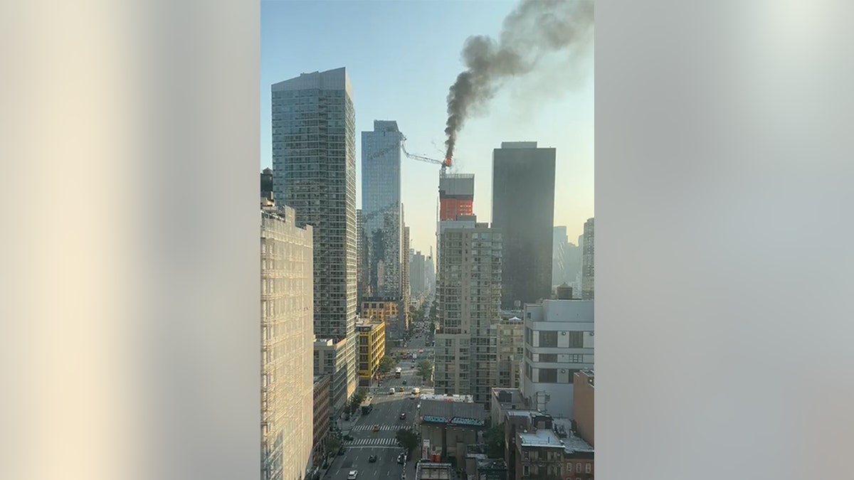 Crane collapsing and hitting a building.