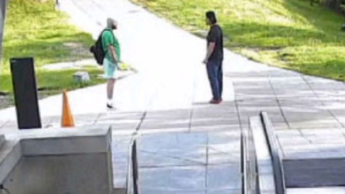 Maxwell Emerson, left, talking to Jaime Macedo (left) outside Metro station