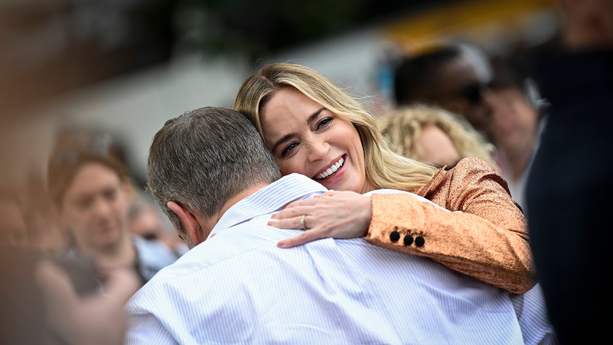 Emily Blunt hugs Matt Damon at the "Oppenheimer" photocall