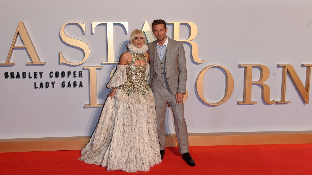 Lady Gaga and Bradley Cooper smile together on the red carpet for "A Star Is Born"