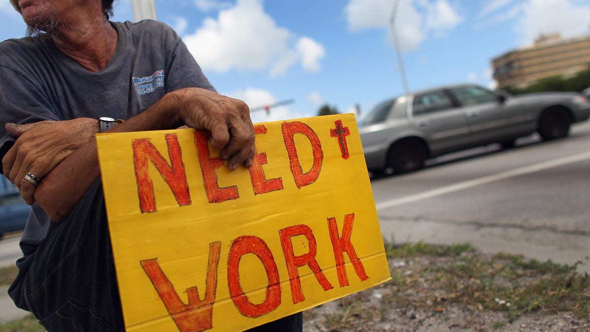 Stephen Greene works a street corner hoping to land a job as a laborer or carpenter on June 3, 2011 in Pompano Beach, Florida.