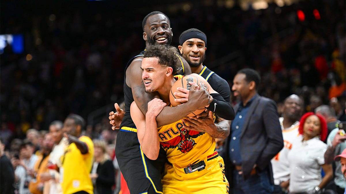 Draymond Green fouls Trae Young