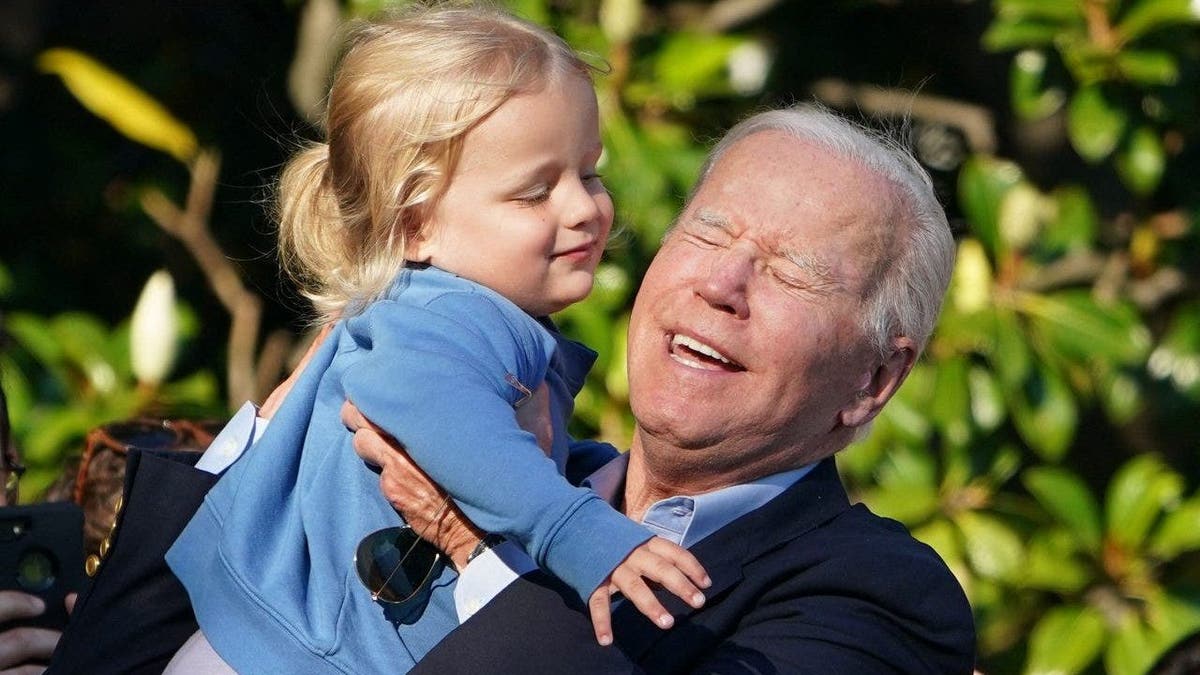 US President Joe Biden lifts grandson Beau