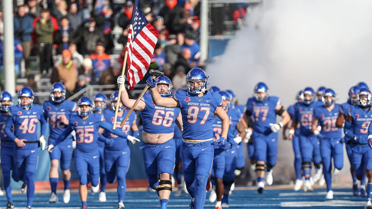 The Broncos run onto the field