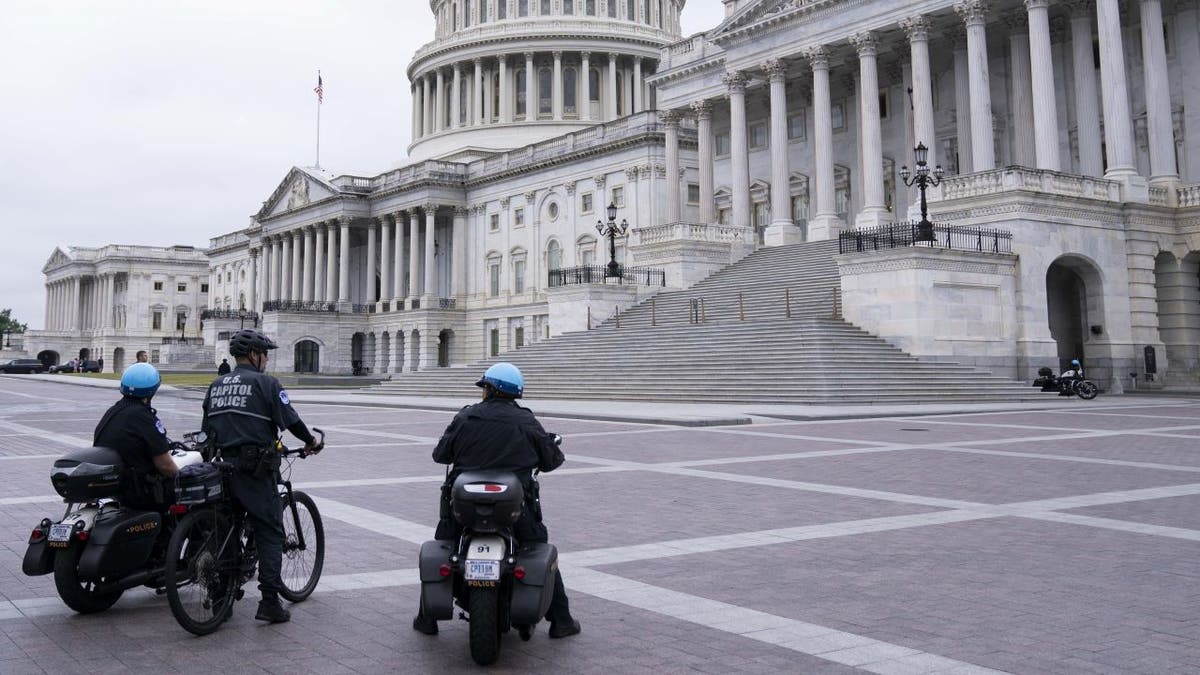 Capitol Police on bicycle, motorcycles outside East Front of US Capitol