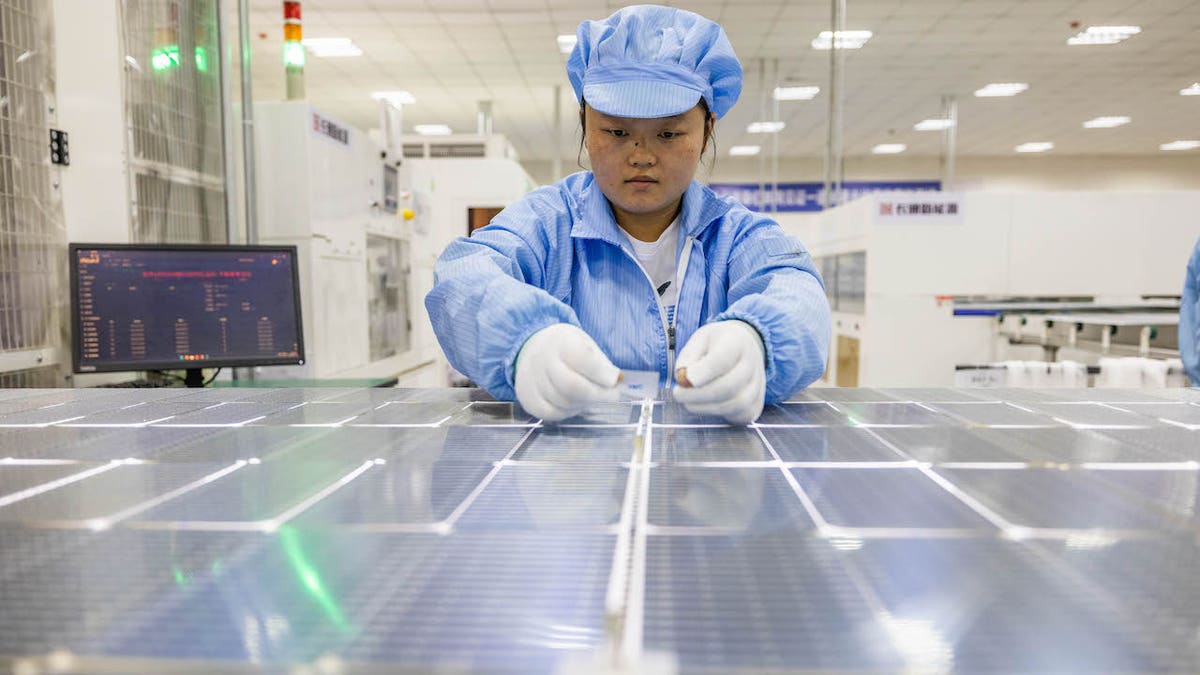 Workers build a solar panel at an energy industrial park in Bijie, China, on June 11, 2023. China has a greater than 80% share in all the manufacturing stages of solar panel manufacturing.