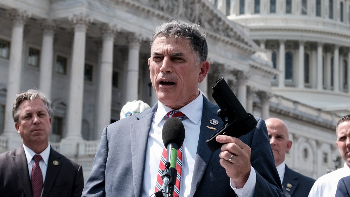 Rep. Andrew Clyde, R-Ga., holds a pistol brace as he speaks to the press during a press conference on Capitol Hill on June 13, 2023 in Washington, D.C.