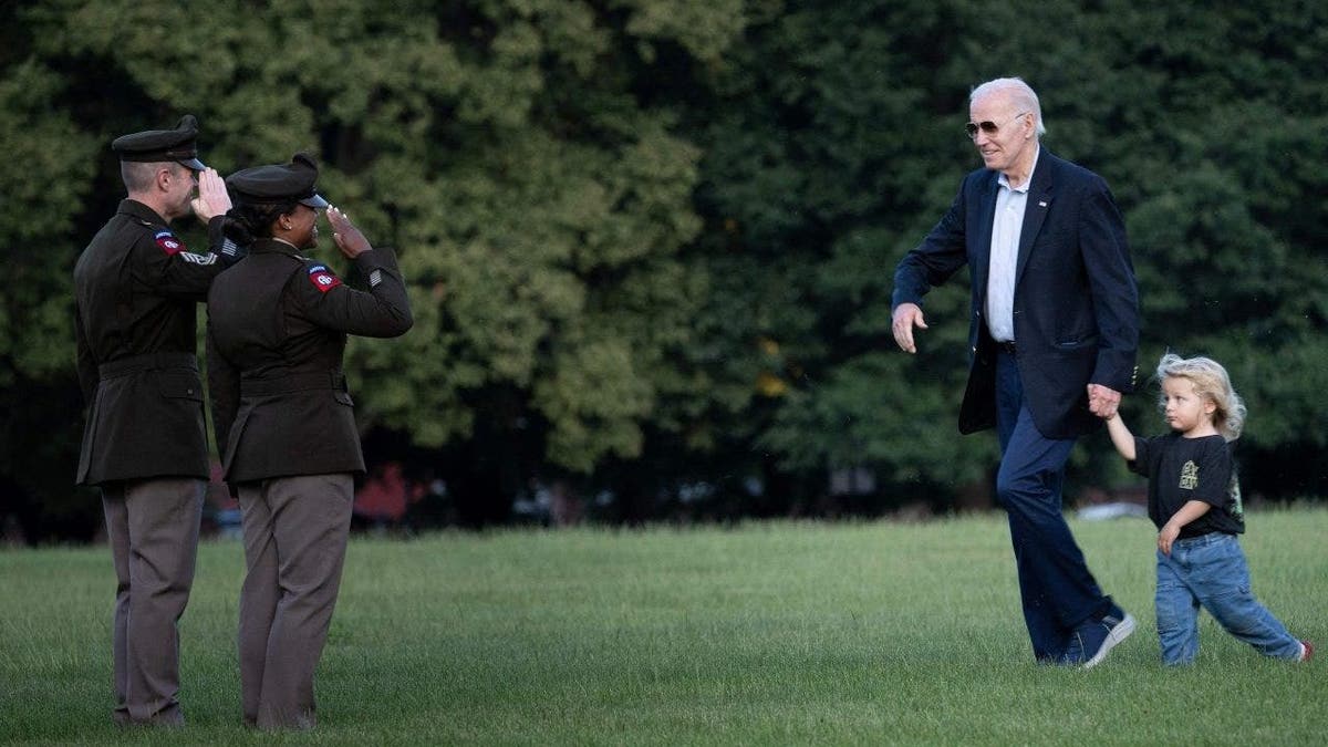 Joe Biden walks with his grandson Beau Biden after arriving on Marine One