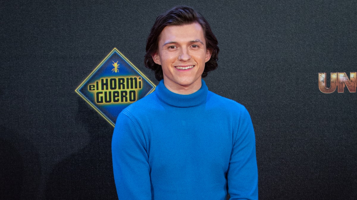 Tom Holland in a blue sweater