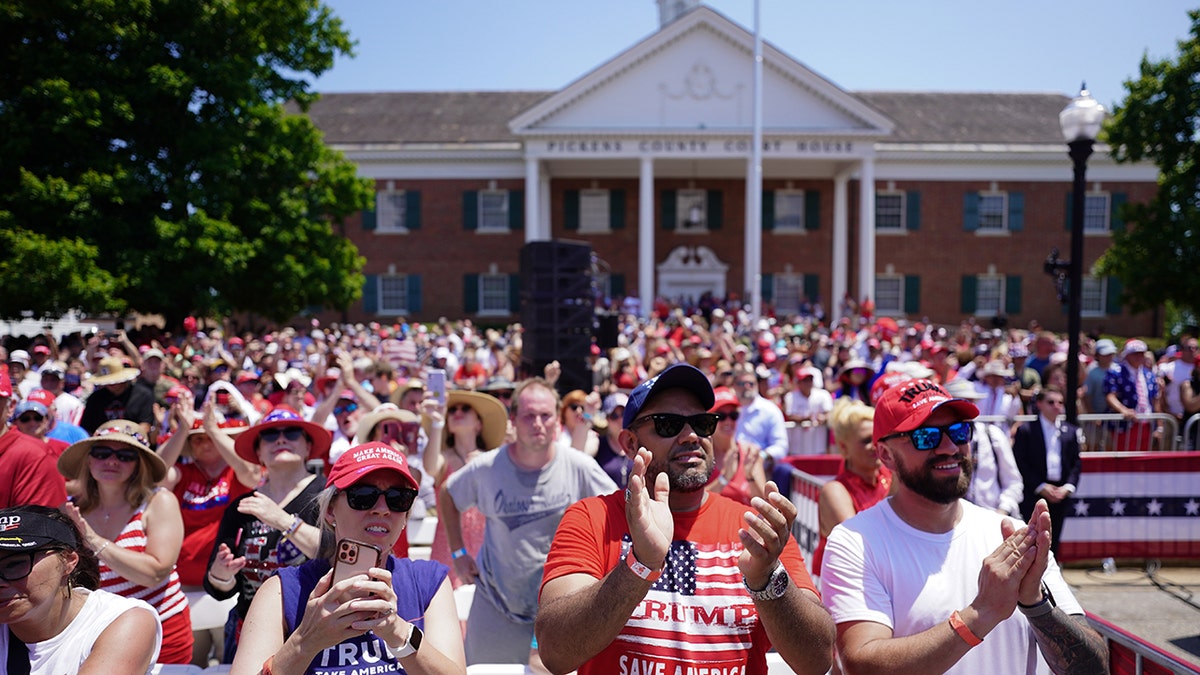 People clapping in front of the state house