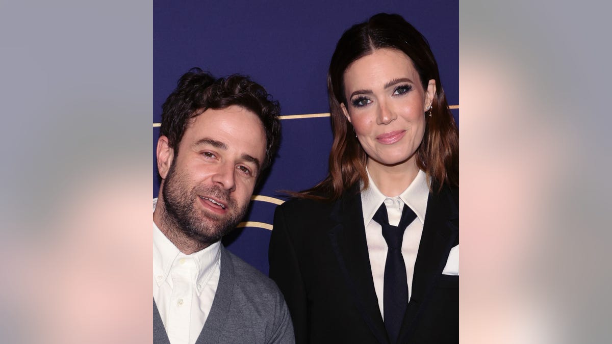 Taylor Goldsmith leans into wife Mandy Moore on the carpet