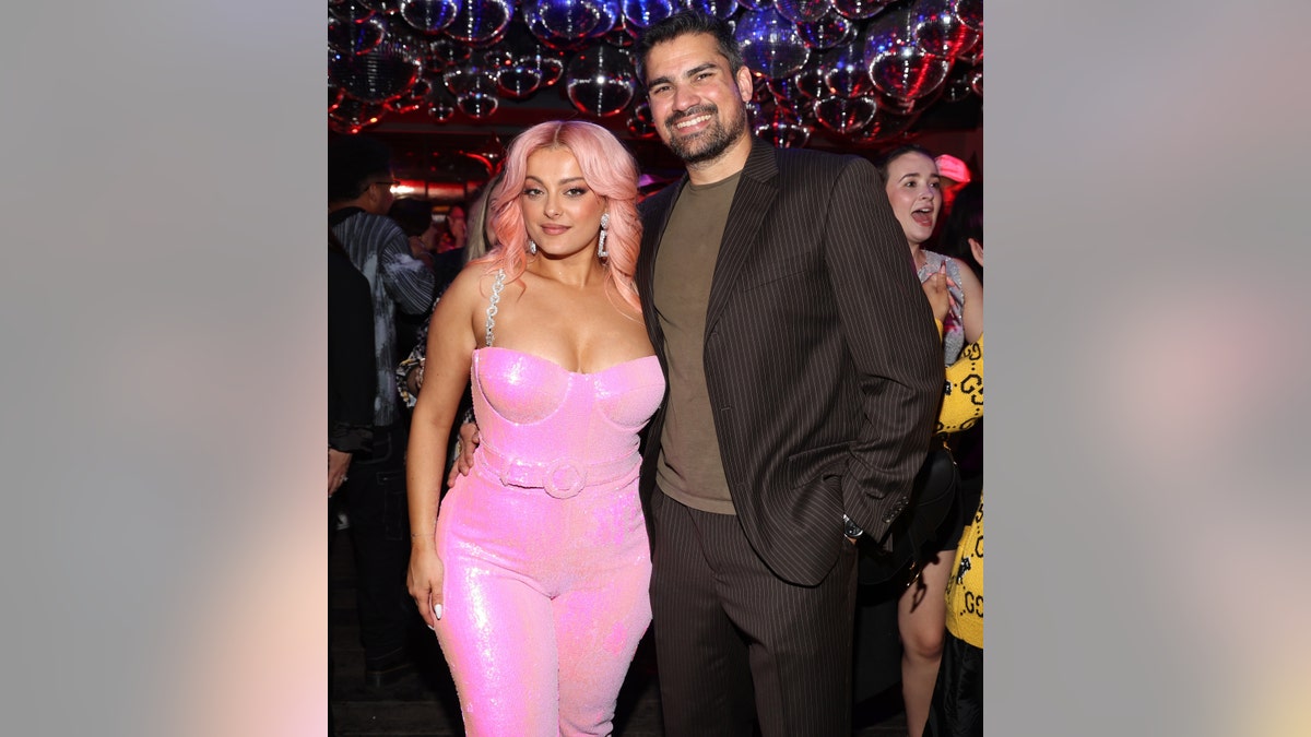 Bebe Rexha in a pink dress and hair with her boyfriend Keyan Safyari at her album release party