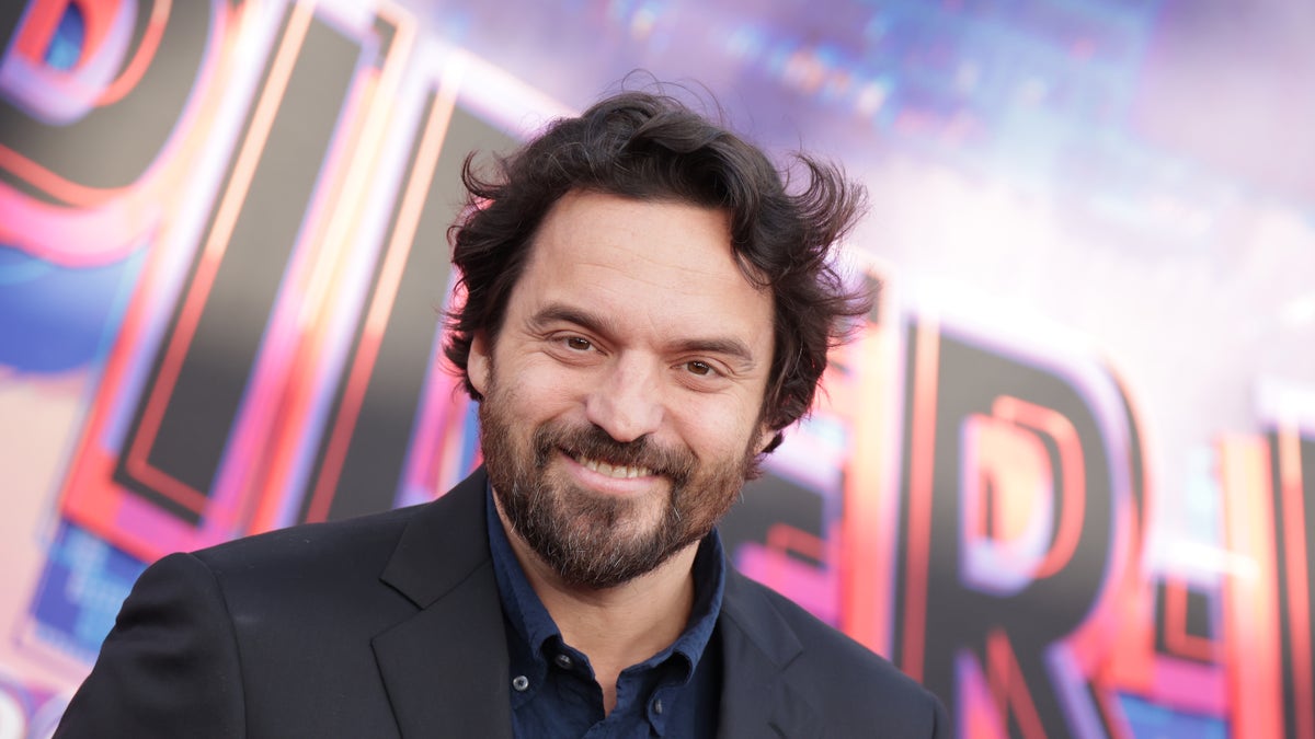 Jake Johnson with a beard on the Spider-Verse red carpet