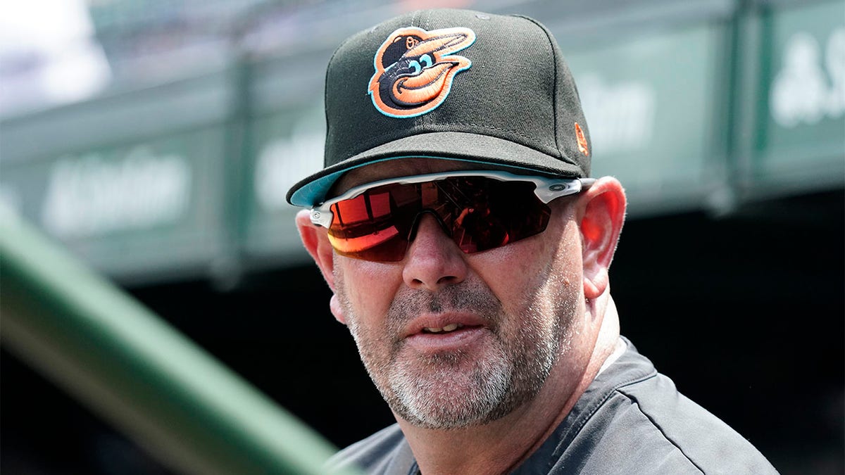 Brandon Hyde stands in the dugout before a game against the Cubs