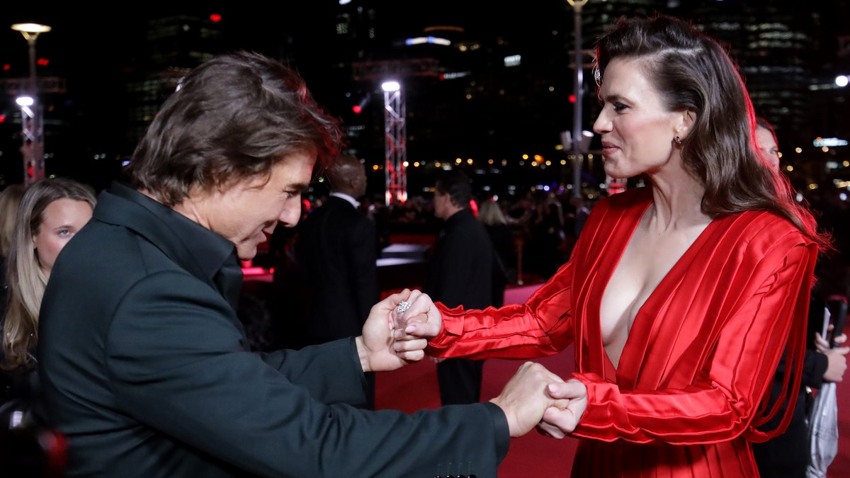 Tom Cruise takes Hayley Atwell's hands during a "Mission Impossible" premiere in Australia