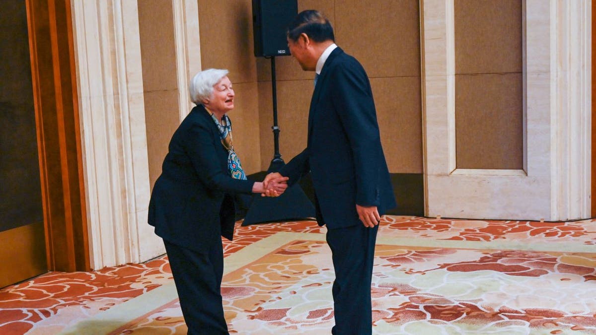 Janet Yellen bowing to Chinese official
