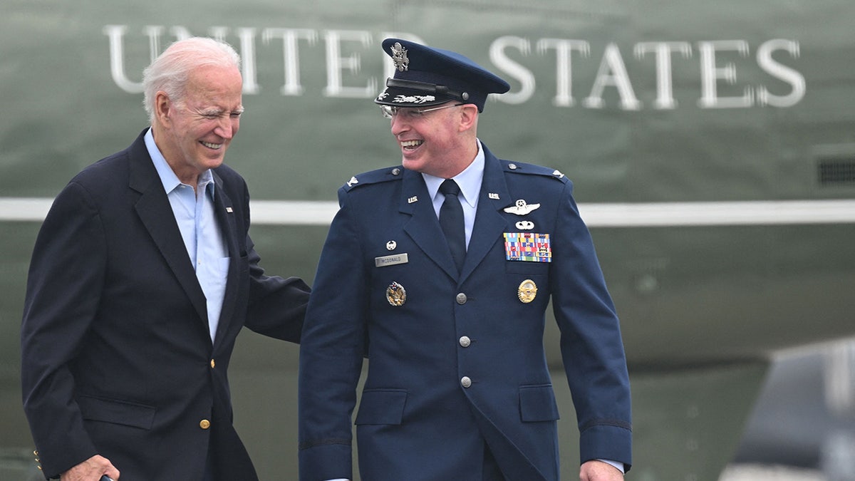 Biden walks to board Air Force One to depart for the UK