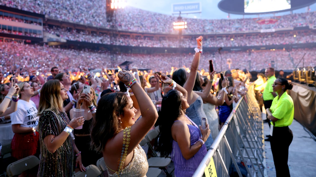 Crowd of Taylor Swift fans behind a barrier at her concert in Kansas City
