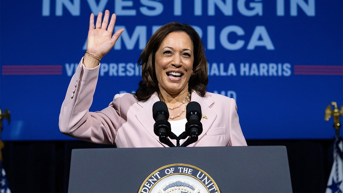 Vice President Kamala Harris waving from podium