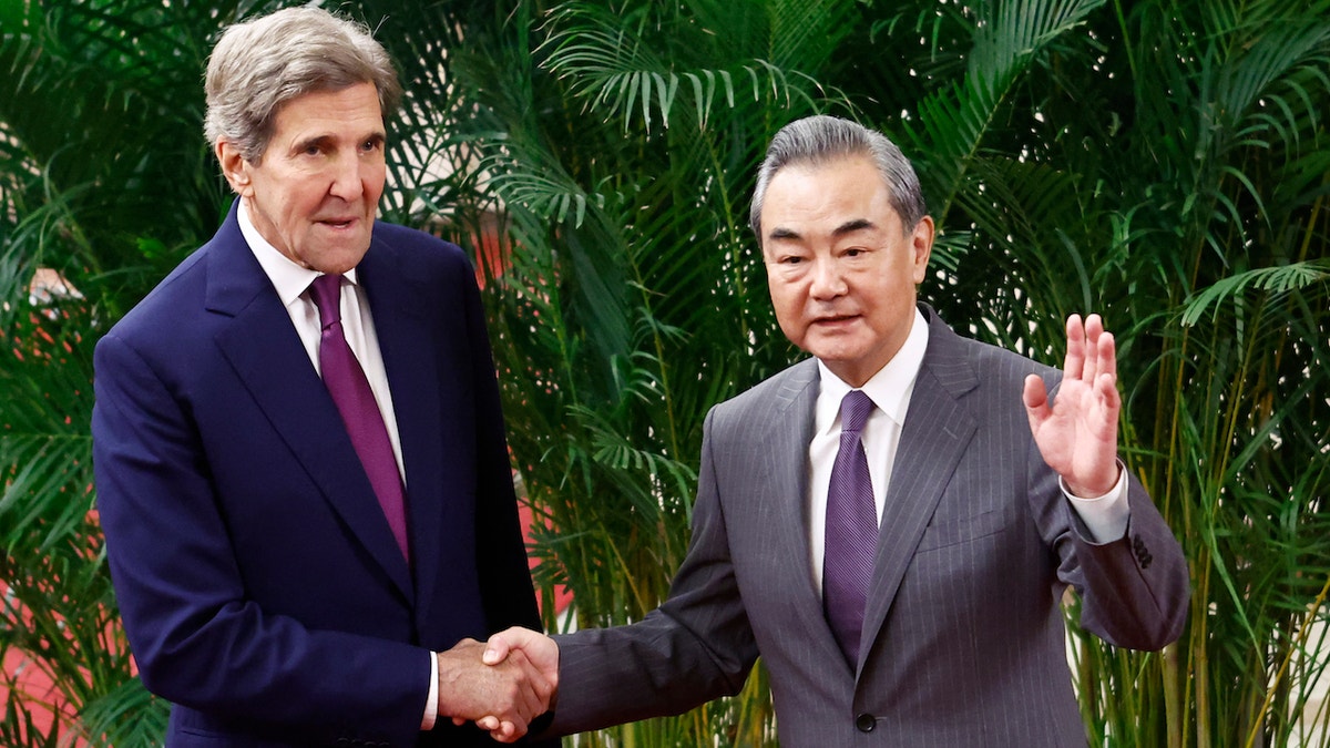 BEIJING, CHINA - JULY 18: U.S. climate envoy John Kerry (L) is greeted by top Chinese diplomat Wang Yi before a meeting in the Great Hall of the People on July 18, 2023 in Beijing, China. Kerry is in Beijing to restart climate negotiations between the world's two biggest polluters, which together account for nearly 40 percent of global emissions. Last year, China cut off climate talks in protest of then-U.S. House Speaker Nancy Pelosi's vist to Taiwan. (Photo by Florence Lo-Pool/Getty Images)