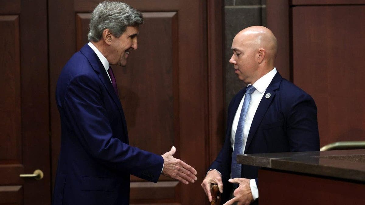 John Kerry (L) and Rep. Brian Mast (R-FL) (R)