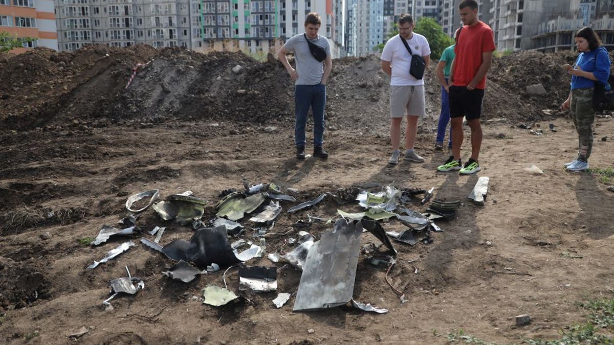 fragments of missile in street with onlookers