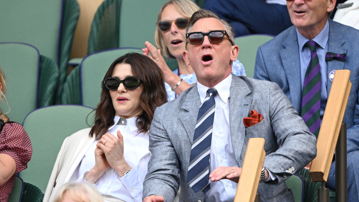 Rachel Weisz and Daniel Craig wear sunglasses in the stands at Wimbledon.