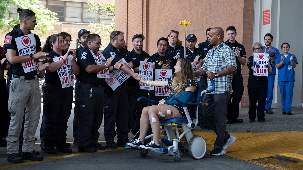 EMTs wait and applaud outside hospital
