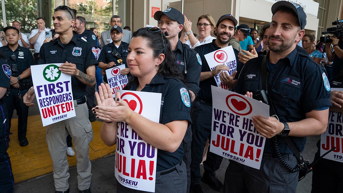 EMTs applaud outside hospital