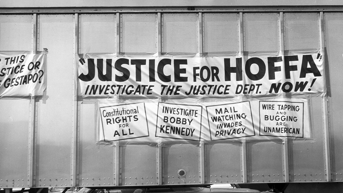 Signs on the side of a truck calling for justice for Jimmy Hoffa