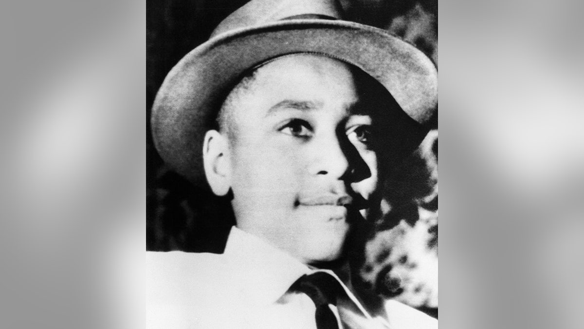 Emmett Till wears a hat and buttoned shirt and tie in a photo before his murder