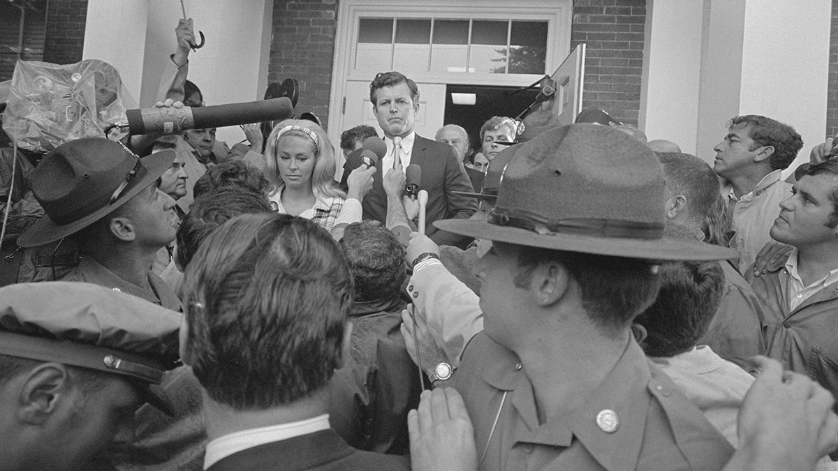 Sen. Ted Kennedy outside of a court house surrounded by reporters