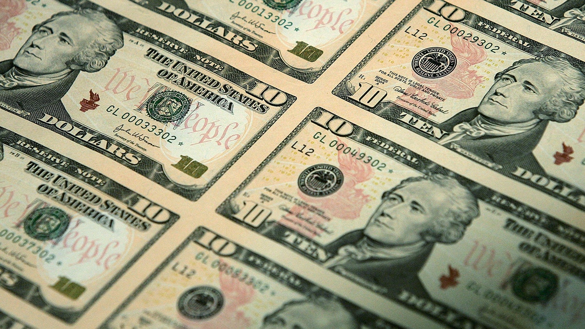 An uncut sheet of many $10 bills