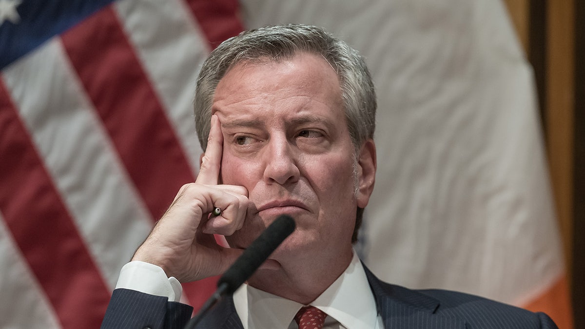 Then-NYC Mayor De Blasio looking pensive during a press conference at NYPD headquarters