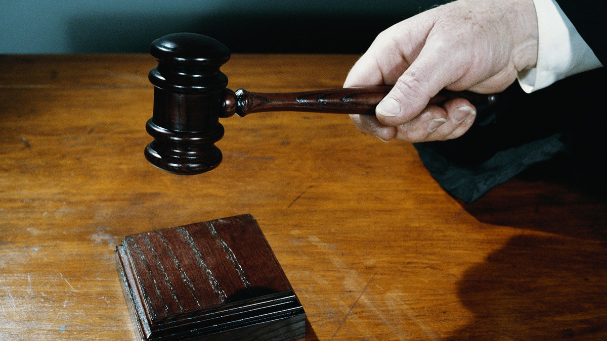 hand holding gavel stock image